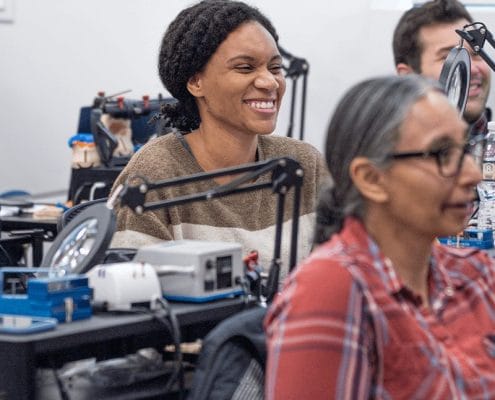 woman smiles at dental ce lecture